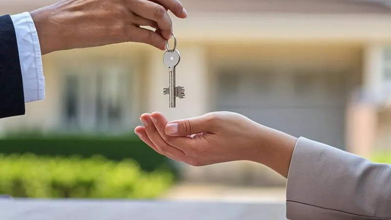 Handshake with keys representing a 1031 exchange replacement property
