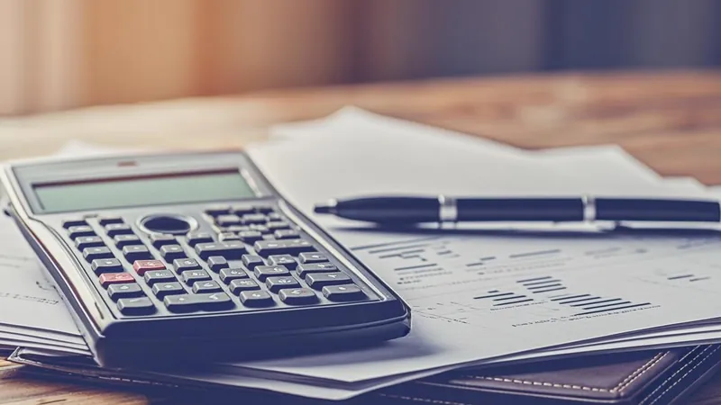 Calculator and financial documents on a desk during tax bracket planning review